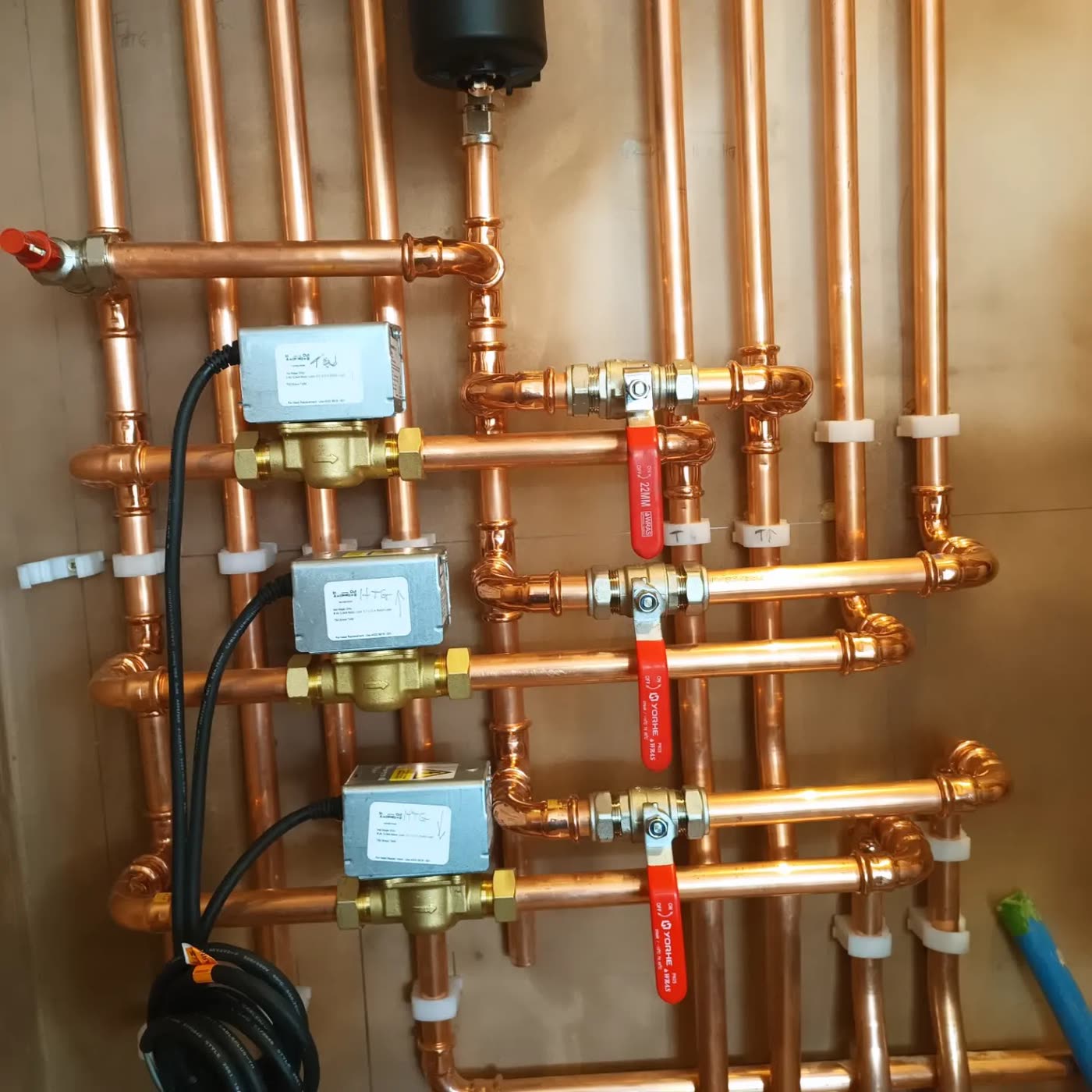 Soldered copper runs, neat and accessible.